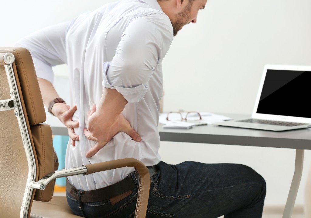 man in office with back pain