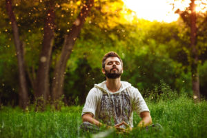 man meditating outdoors