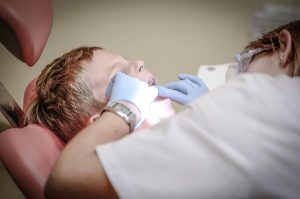 kid at dentist check up