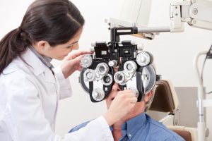 eye doctor using an apparatus on her patient