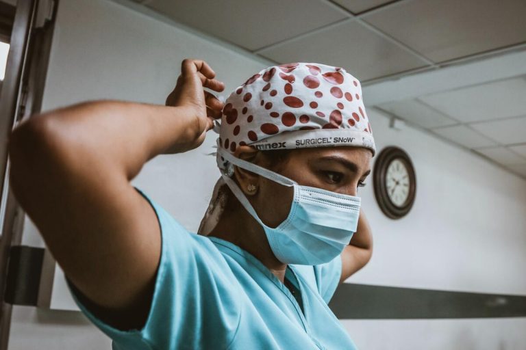 resident nurse helping in surgery