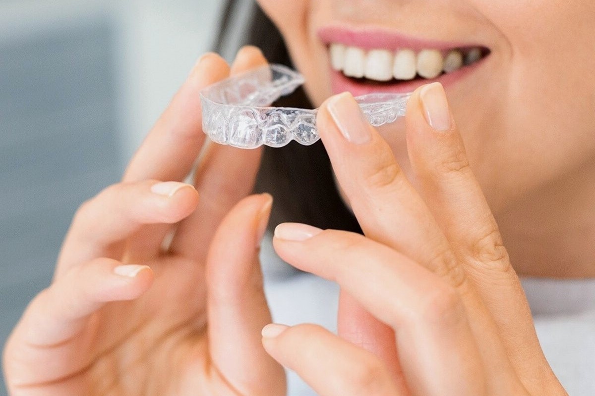 woman removing her aligners