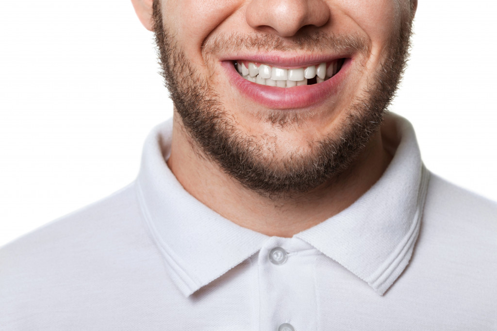 Man smiles showing missing tooth