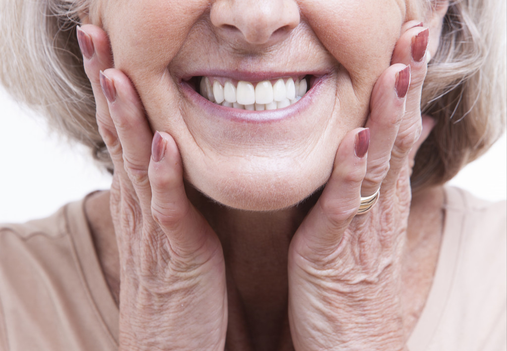 senior wearing her dentures while smiling