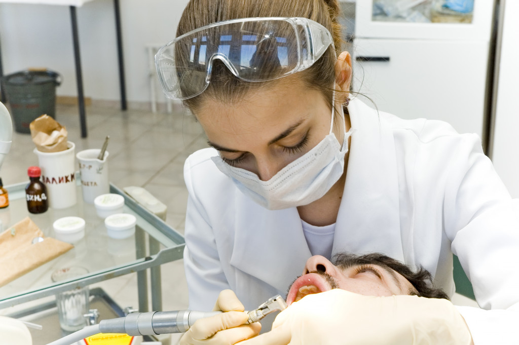 A dentist checking for oral cancer