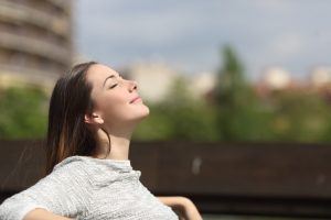 young happy woman with eyes closed