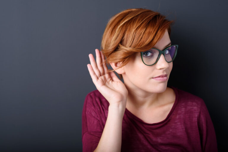 A Woman Cupping Hand behind the Ears