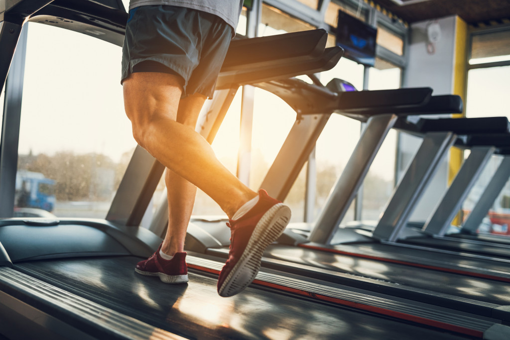 a man running on a treadmill inside a gym