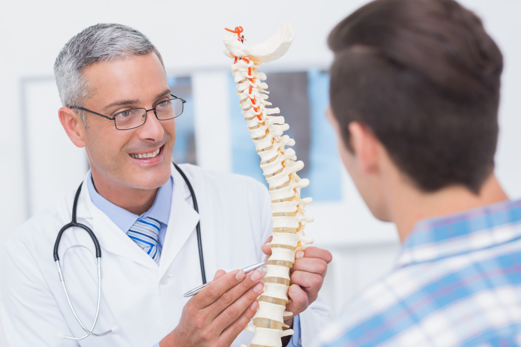 A doctor explaining spinal health to a patient