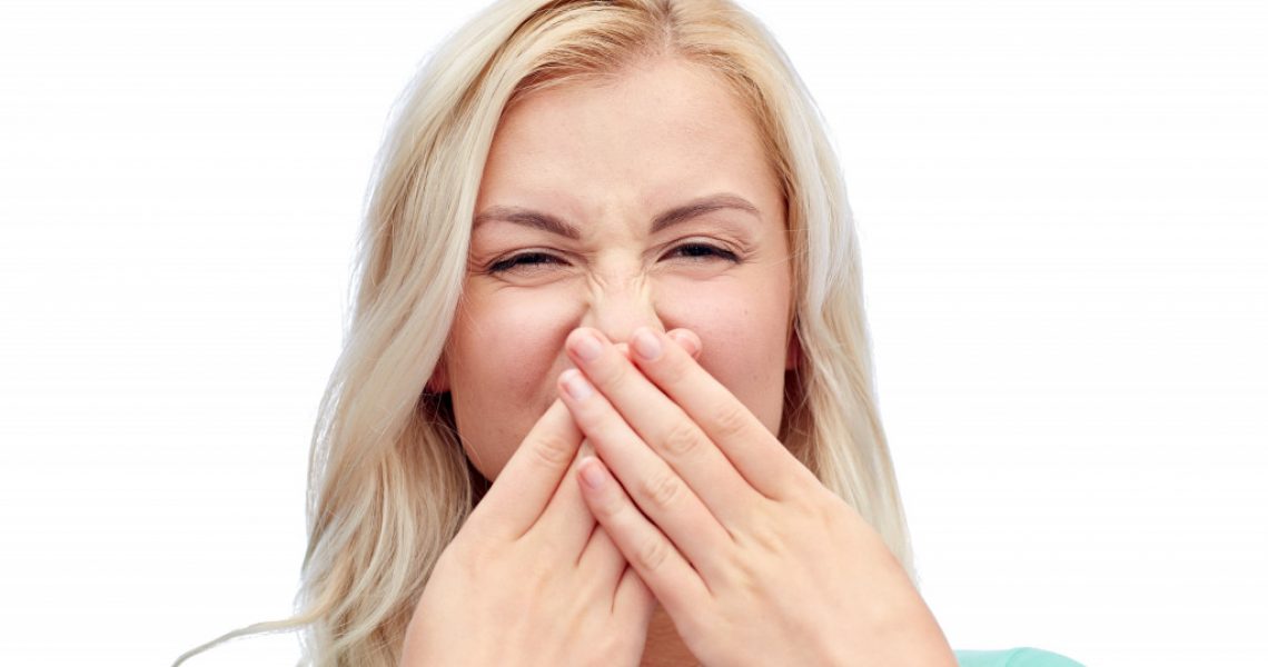 woman covering her mouth and nose